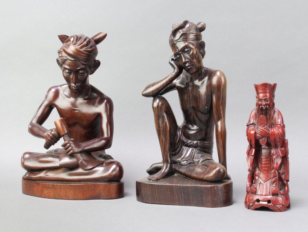 A Bhalian style carved figure of a seated carver 31cm x 22cm x 16cm and 1 other of a seated