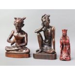 A Bhalian style carved figure of a seated carver 31cm x 22cm x 16cm and 1 other of a seated