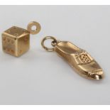 A 9ct yellow gold loafer charm and a ditto dice charm 1.4 grams