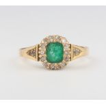 An 18ct yellow gold emerald and diamond cluster ring, size N, 4 grams