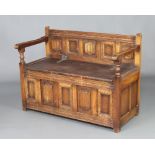 A carved oak hall settle with linenfold decoration 74cm h x 99cm w x 48cm d, the reverse with