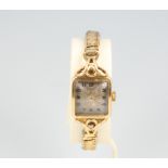 A lady's 9ct yellow gold wristwatch on an expanding gilt bracelet