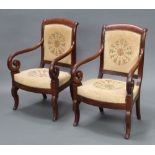 A pair of Empire style mahogany show frame open arm chairs, seats and backs upholstered in Berlin