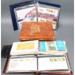 A blue album of Royal Mint Philatelic Numismatic covers together with 4 albums of first day covers