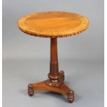 A William IV circular inlaid mahogany occasional table raised on a turned column and triform base