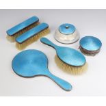 A silver and blue guilloche enamelled dressing table set comprising hair brush, 2 clothes brushes,