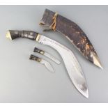 A Kukri, the blade marked India Mandicraft with horn grip and leather scabbard complete with 2