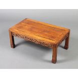 A Chinese rectangular hardwood opium table with pierced apron, raised on square supports 30cm x 71cm