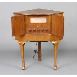 A G Marconi radio, model no. C10 A, serial number A/11 1031, contained in a walnut corner cabinet