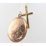 A 9ct yellow gold cross pendant and a gilt locket