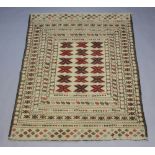 A white and red ground Sumak Kilim with 3 rows of 6 stylised diamonds to the centre 175cm x 129cm