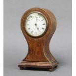 An Edwardian Swiss bedroom timepiece with paper dial and Roman numerals contained in an oak