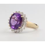 A 9ct yellow gold amethyst and diamond cluster ring size P