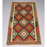 A black, brown and green ground Maimana Kilim rug 194cm x 100cm Slight hole to the weave