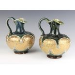 A pair of Royal Doulton green and gilt glazed squat jugs, bases impressed Royal Doulton and