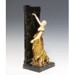 After F Levillain, a bronze and ivory figure/bookend in the form of a standing lady depicting The