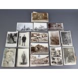 A collection of black and white postcards and photographs, some military