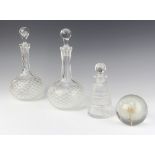 A near pair of moulded glass decanters, a faceted glass scent and a paperweight