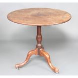 A George III circular mahogany snap top tea table raised on bulbous turned and tripod supports