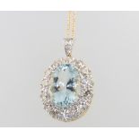 An 18ct yellow gold aquamarine and diamond oval pendant, the centre stone 5.8ct surrounded by