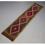 A purple, red, green and black ground Suzni Kilim runner with 4 diamonds to the centre 248cm x 57cm