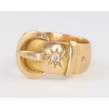 An 18ct yellow gold diamond set buckle ring, size K 1/2, 6.3 grams