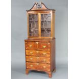 A Georgian inlaid mahogany secretaire bookcase the upper section with broken pediment, fitted