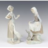 A Lladro figure of a standing lady with seated rabbit, base impressed 4826 23cm h together with 1