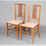 A pair of Edwardian inlaid mahogany stick and rail back bedroom chairs Slight scratching to the
