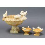 A 1920's circular carved alabaster urn decorated 3 doves, raised on square base 15cm h x 25cm