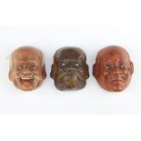 Three Japanese miniature lacquered face masks 5cm x 4cm