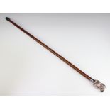 A hardwood walking cane with a silver filled owl grip
