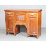 An Edwardian walnut sideboard, the centre fitted a fall front above a recess flanked by drawers