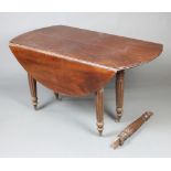 A 19th Century mahogany oval drop flap extending dining table raised on 6 turned and fluted supports