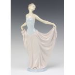 A Lladro figure of a standing girl wearing a ball gown base marked B&P 32cm