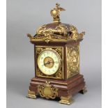 A 19th Century mantel timepiece with enamelled dial and Arabic numerals contained in an oak and gilt