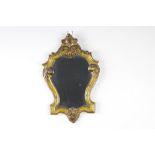 An Italian Rococo style shield shaped mirror contained in a gilt painted frame 39cm h x 25cm w