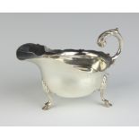 A Victorian silver sauce boat with wavy border and C scroll handle, London 1895, 178 grams