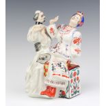 A Soviet Russian porcelain figure group of a seated couple, the base marked K, 21cm h