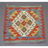 A terracotta, green and white ground Chobi Kilim rug 50cm x 50cm