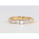 An 18ct yellow gold baguette brilliant cut diamond ring size K 1/2, 3.7 grams