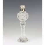 An Edwardian style silver mounted cut glass scent with waisted stem and repousse lid, 11cm The glass