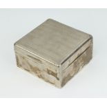 A silver cigarette box with engine turned decoration, London 1926-1927, 4cm x 8cm x 8cm There is a