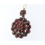 A 9ct yellow gold garnet pendant and chain 7.7 grams