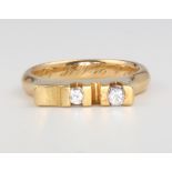 An 18ct yellow gold 2 stone diamond ring, size K, approx. 0.10ct, 6 grams