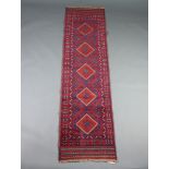 A red and blue ground Meshwani runner with 5 diamonds to the centre within a multi row border