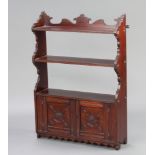 An Edwardian mahogany hanging 3 tier wall shelf, the base enclosed by panelled doors 83cm h x 60cm w