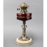 An Arts and Crafts faceted glass oil lamp reservoir raised on a coppered glass base with white