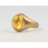 A 9ct yellow gold cabochon cut gem set ring, size J, 3.1 grams