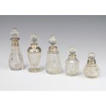 An Edwardian silver mounted toilet bottle, London 1904, 7cm and 4 others All bottles have minor